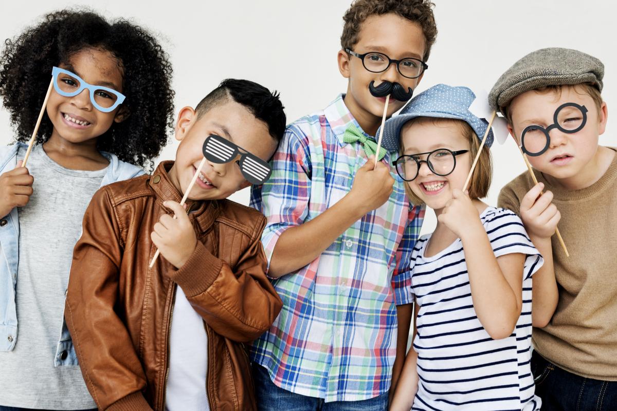 A group of five kids wearing funny glasses.